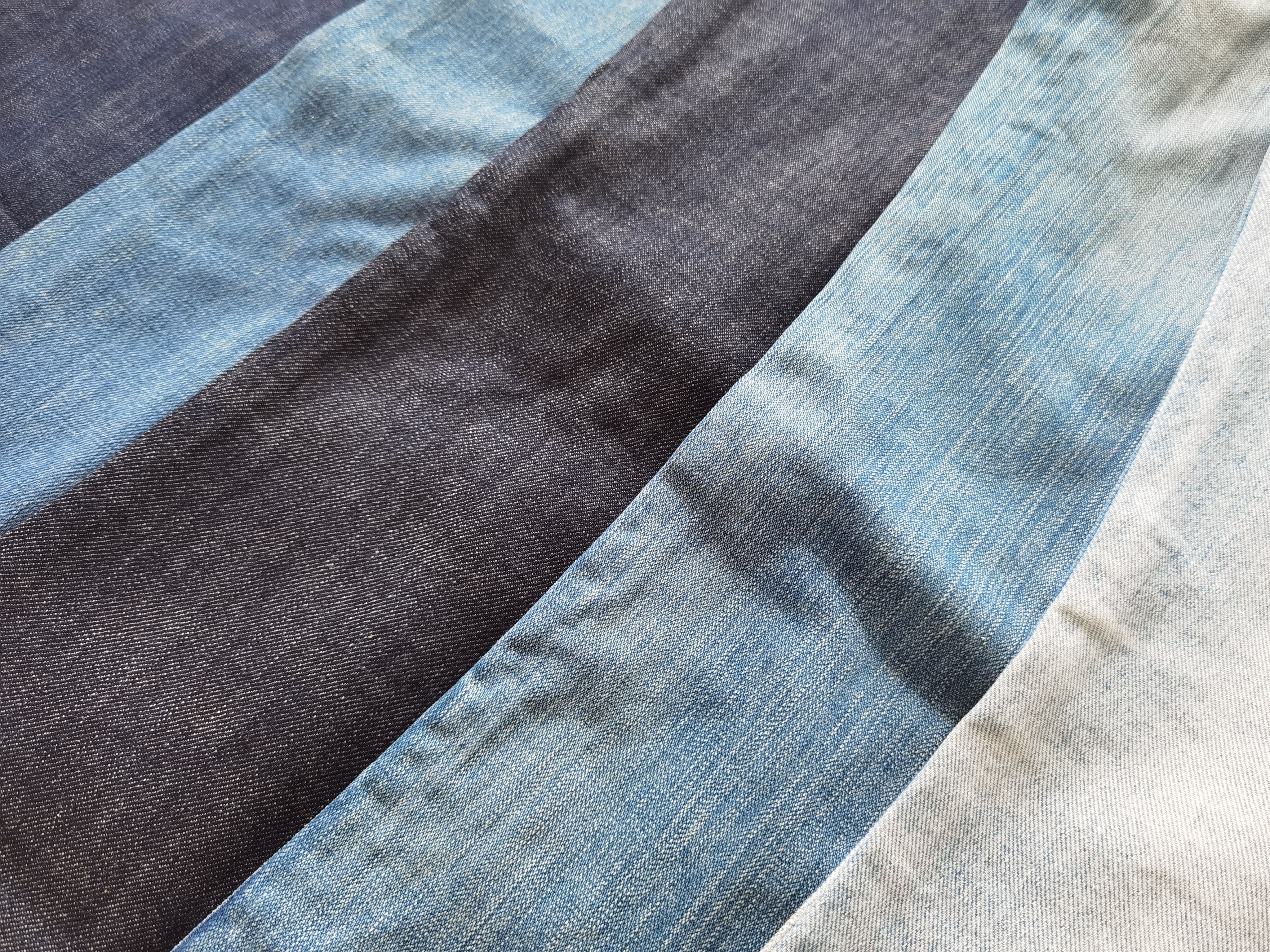 Denim fabrics showing different wash shades and color depth